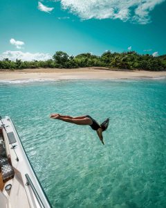 Women Diving Into Beach on 64' Azimut Flybridge